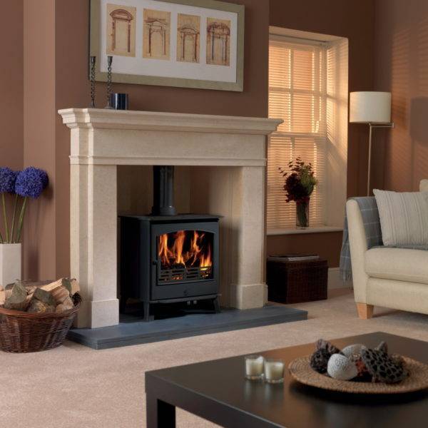 Astwood Wood burner lit in solid stone fireplace